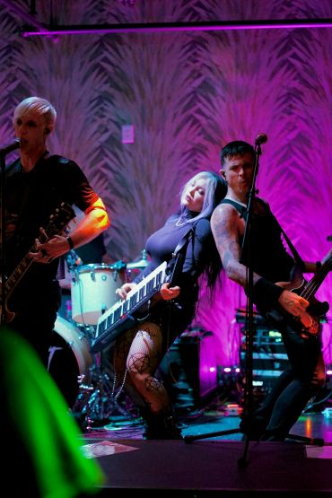 Band performing live with vibrant lights.