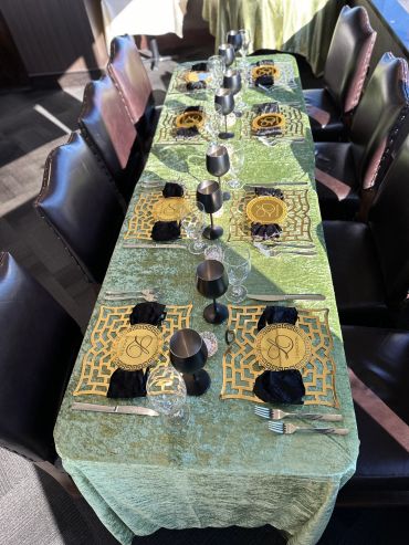 Elegant dining table set with gold and black accents.