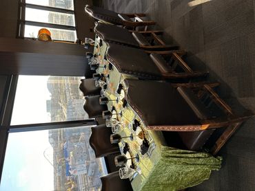 Elegant dining table set for a meal with city view.