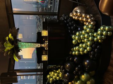 Elegant black and gold balloon decoration around a piano.