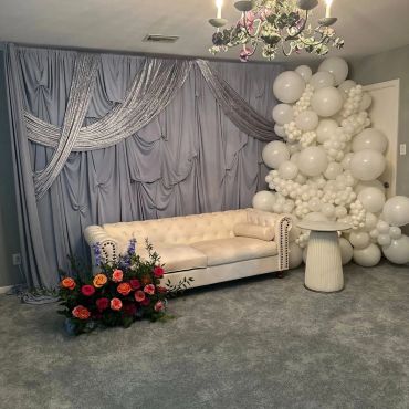 Elegant decorated photo corner with balloons and floral arrangement.