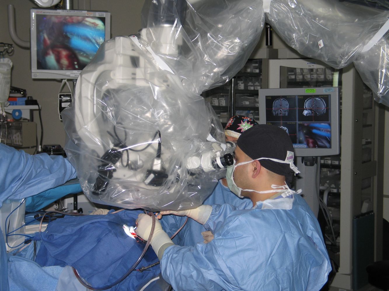 Surgeons performing a delicate operation using advanced medical imaging technology.