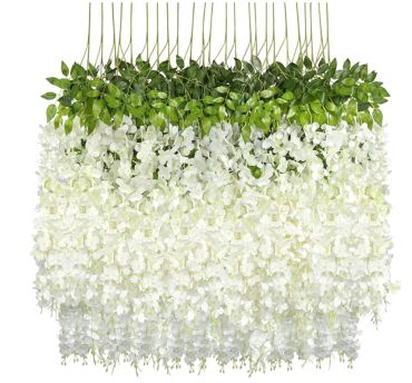 Artificial white wisteria flower strands with green leaves arranged for decoration.