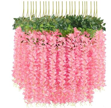 Hanging artificial pink wisteria flowers with green leaves.