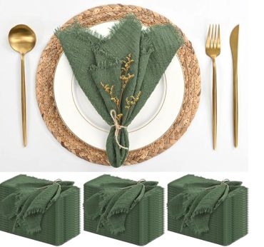 Elegant table setting with green napkin and gold cutlery on a woven placemat.