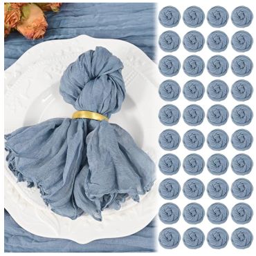 Set of 50 blue cloth napkins on a white plate with flowers.