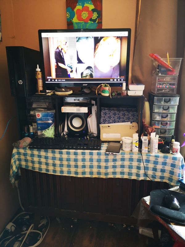 Client 1, living room computer desk, cluttered with miscellaneous items