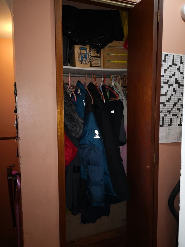 Client TM, hallway closet, cluttered. 