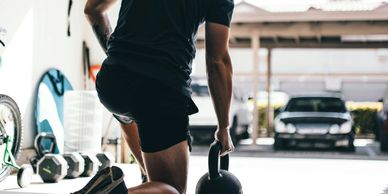 Man kneeling next to kettlebell