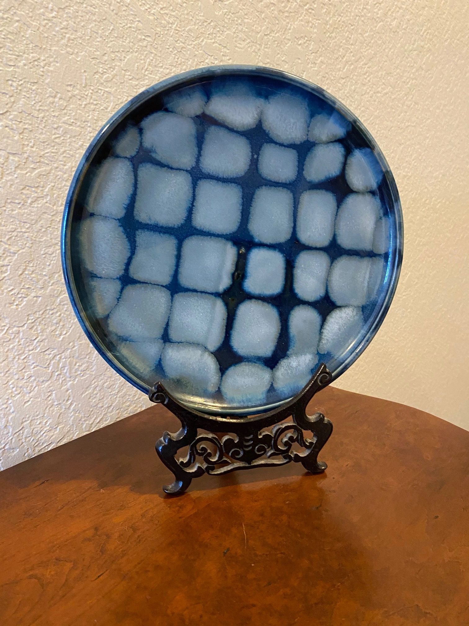 This is a navy and light blue plate with woven glaze pattern.