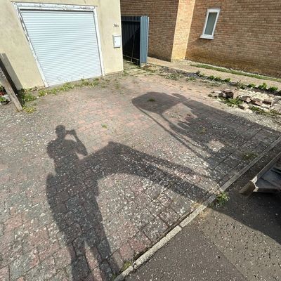 Resin-bound driveway and backyard upgrade in Saffron Walden with modern edging and smooth finish