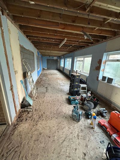 Stripped interior renovation prep with exposed flooring and base ready for new installation UK