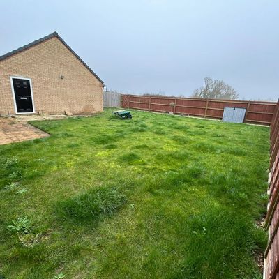 Overgrown garden in Thorney before landscaping with uneven ground poor levels and no usable space