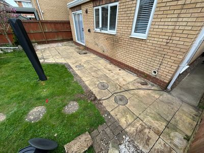 Tired stained patio slabs before resin bound transformation in Huntingdon Cambridgeshire