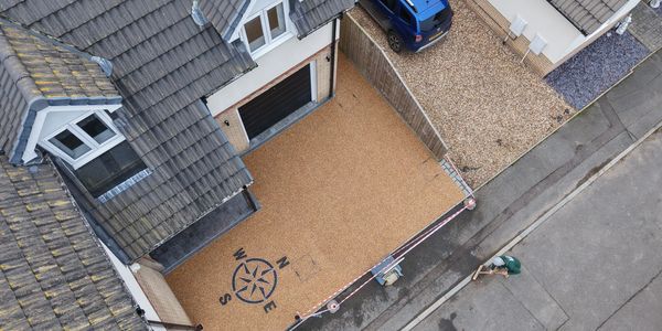 Aerial view of a resin-bound driveway with compass design by Butler’s Resin and Construction.