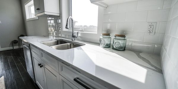 Kitchen Faucet with Cabinets and Marble Countertop