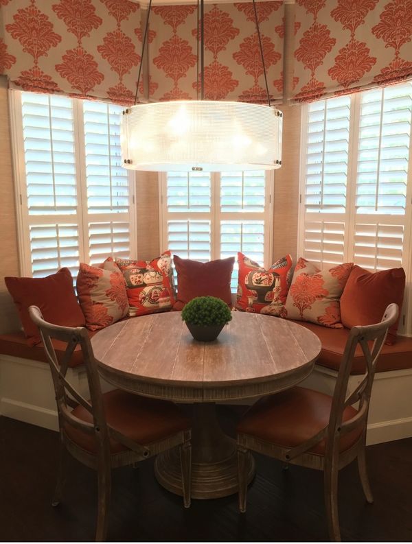 Cozy breakfast nook with cushioned seating and wooden table.