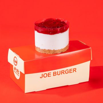 A layered dessert with red topping on a Joe Burger box.