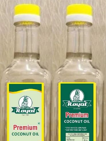 Two bottles of Royal Premium Coconut Oil with yellow caps.