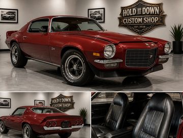 Classic maroon muscle car showcased indoors at Hold It Down Custom Shop.