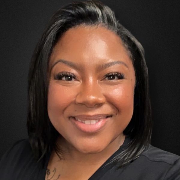 Smiling woman with straight black hair.