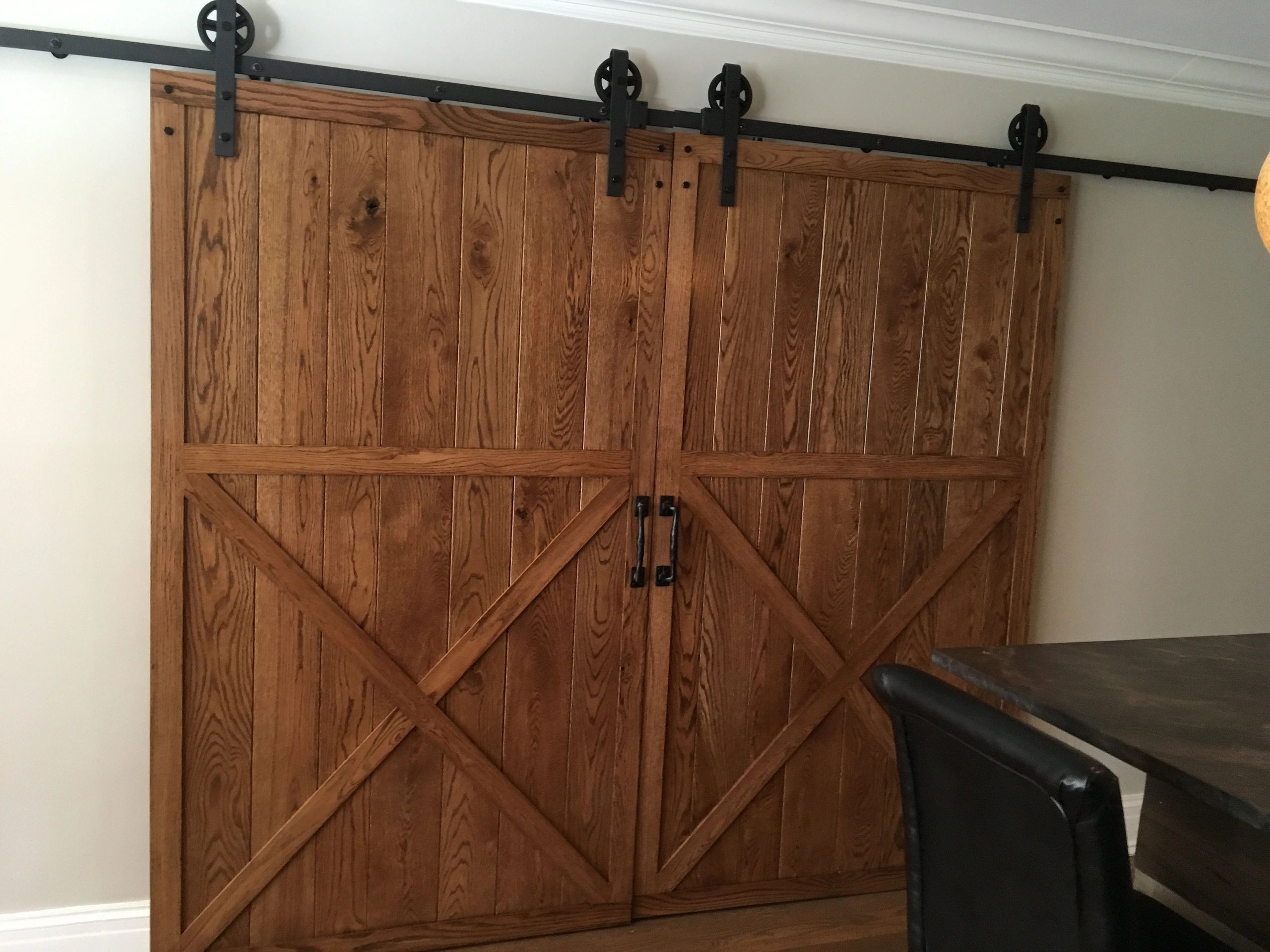 Rustic wooden barn doors with black metal hardware.