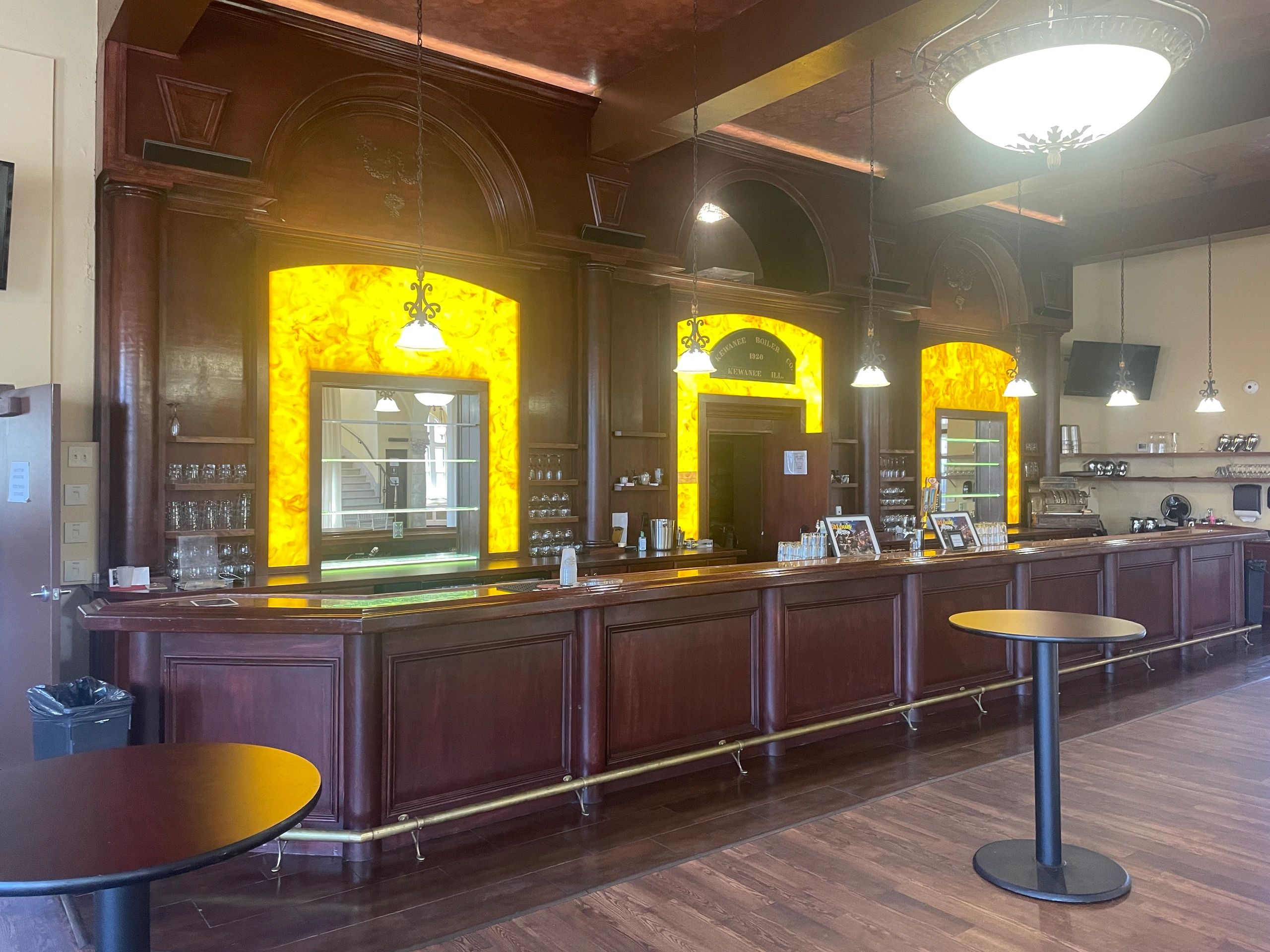 Classic bar interior with wooden decor and warm lighting.