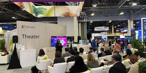 Audience attending a presentation at the Microsoft Theater booth.