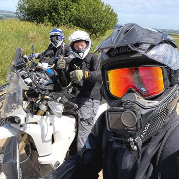 Small group of riders enjoying a guided green lane adventure in the UK countryside.