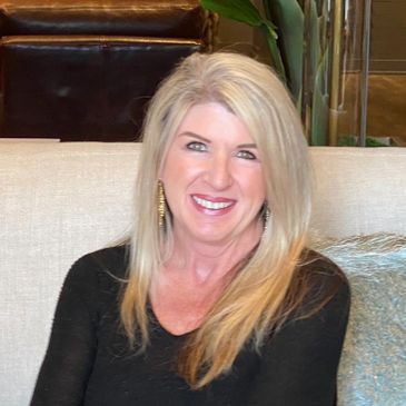 blonde woman wearing black sweater sitting on couch