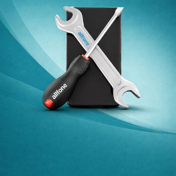 Smartphone with a wrench and screwdriver crossed in front of it.