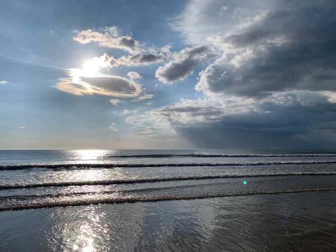 Two people in a formal setting reviewing documents at a wooden table.