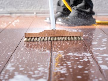 Washing exterior patio with a brush