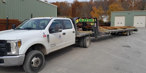 Hot shot truck and gooseneck trailer hauling range 3 drill pipe 