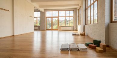 Empty yoga studio with mats and blocks.