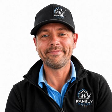 Man wearing a Family Paint Pro jacket and cap, smiling.
