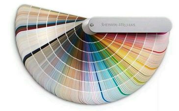 A Sherwin-Williams paint color fan deck showing a wide range of colors.