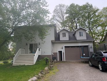 Suburban two-story house with a driveway and attached garage.