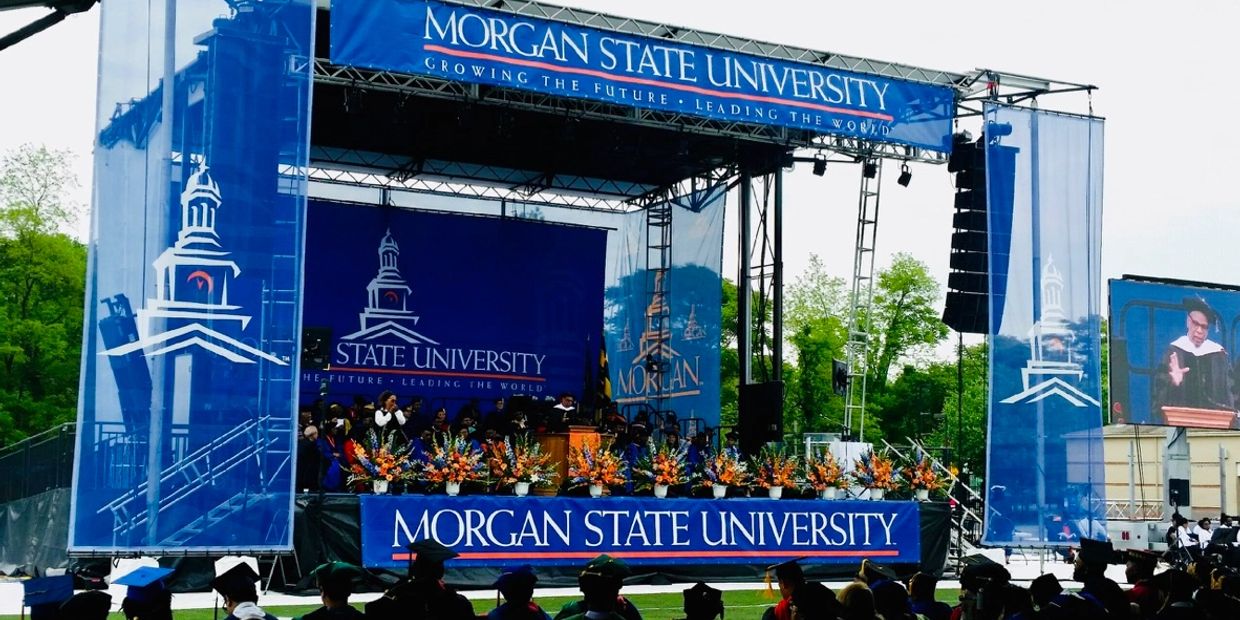Morgan State University graduation ceremony with a decorated stage.