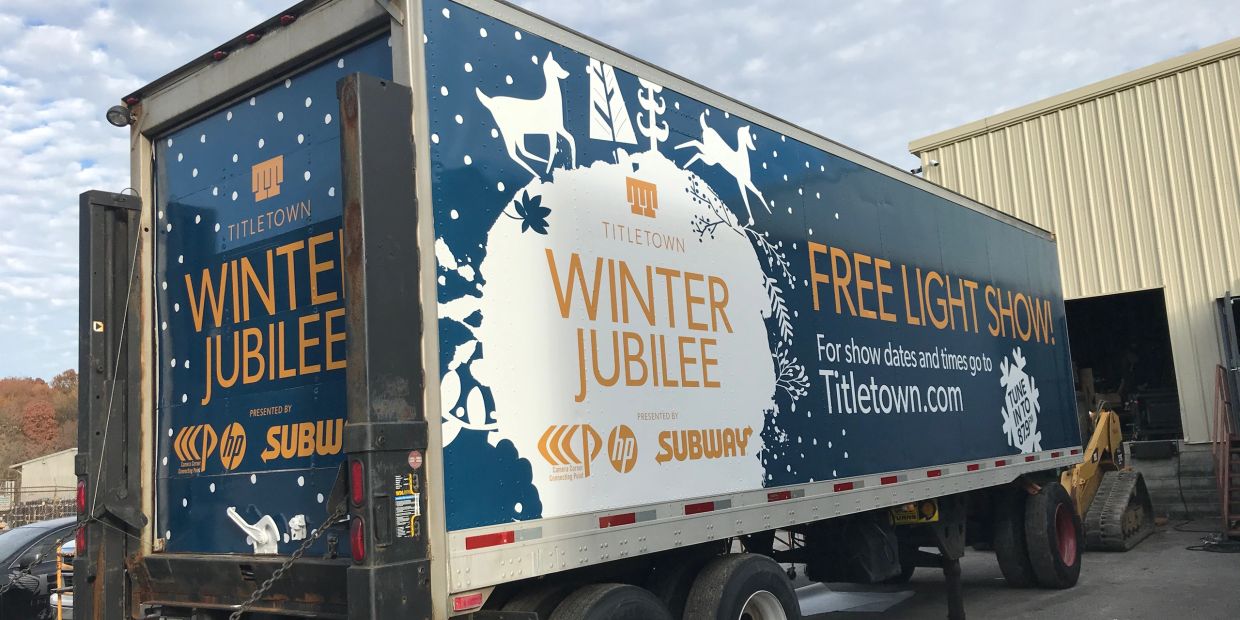 Truck trailer advertising Titletown Winter Jubilee free light show.