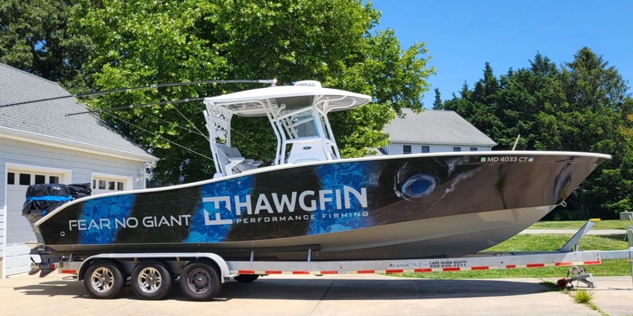 Performance fishing boat on trailer with bold branding.