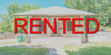 A single-story house with a large red 'RENTED' sign across the image.