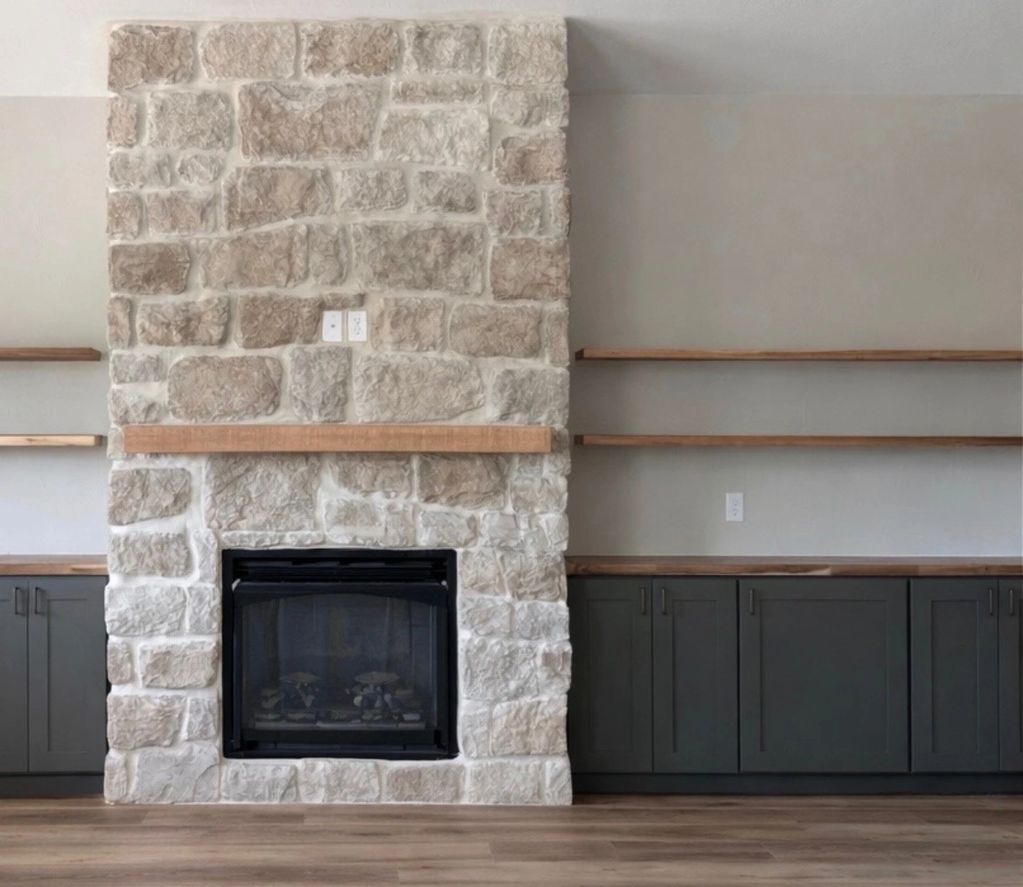 Built-in cabinetry with professionally installed floating wood shelves, creating a clean, balanced layout around the fireplace.