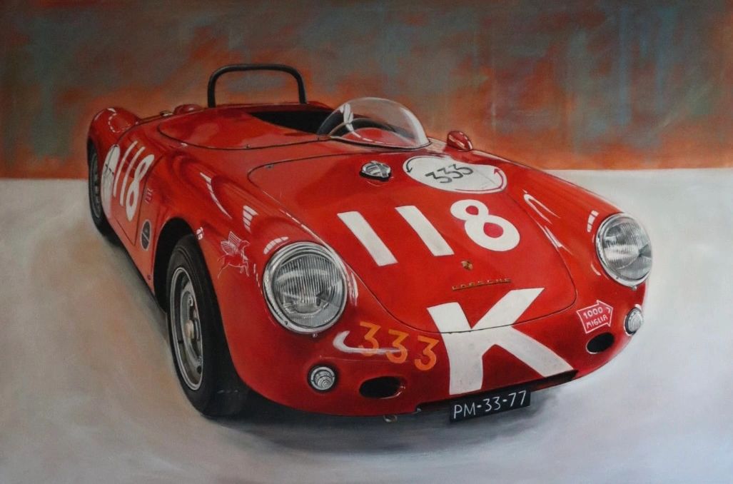 Red vintage Porsche race car with number 118 and racing decals.