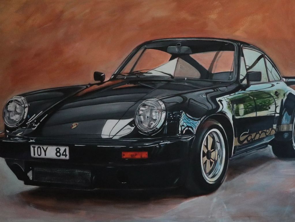 Classic black Porsche Carrera sports car with reflective paint and sleek design.