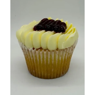 Cupcake with creamy frosting and berry topping.