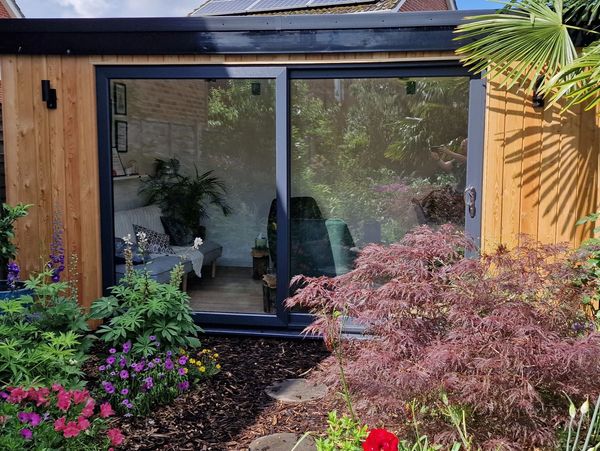 Larch-clad garden office/therapy room, bespoke wooden construction, with high-spec Kingspan insulati