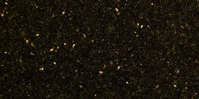 Close-up of dark soil with small seeds scattered.