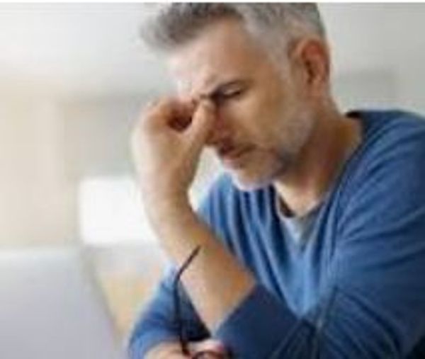 A man holding his nose bridge with pain