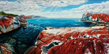 cristle blue water with red rocks meeting the ocean